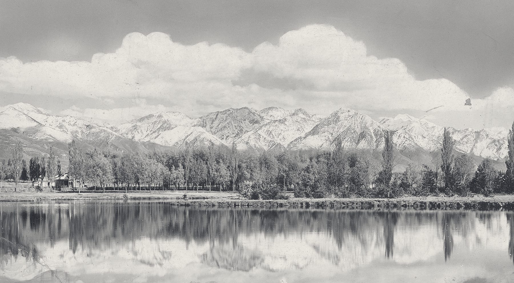 An 1880s photograph of the snow-covered Wasatch Range reflected in the pond at Liberty Park