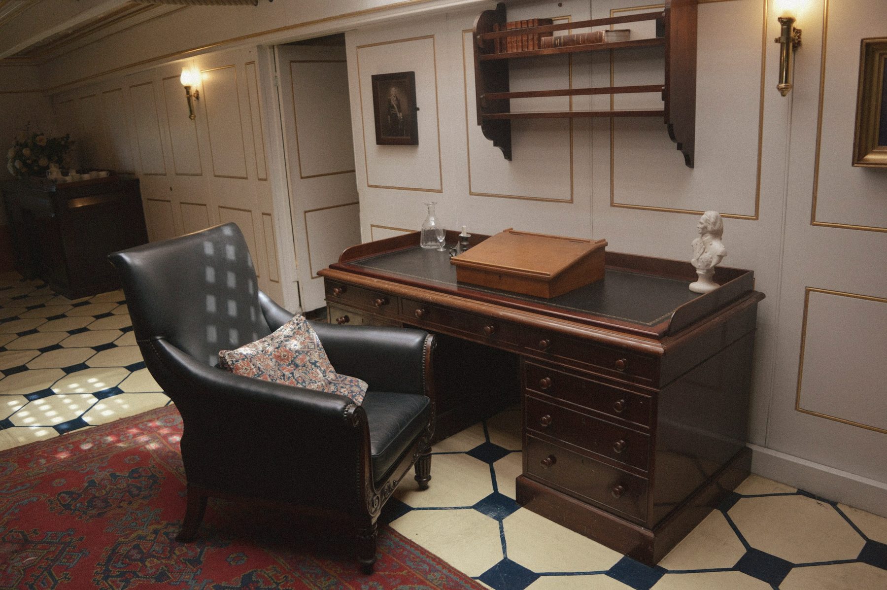 A classic study with a mahogany desk and leather armchair